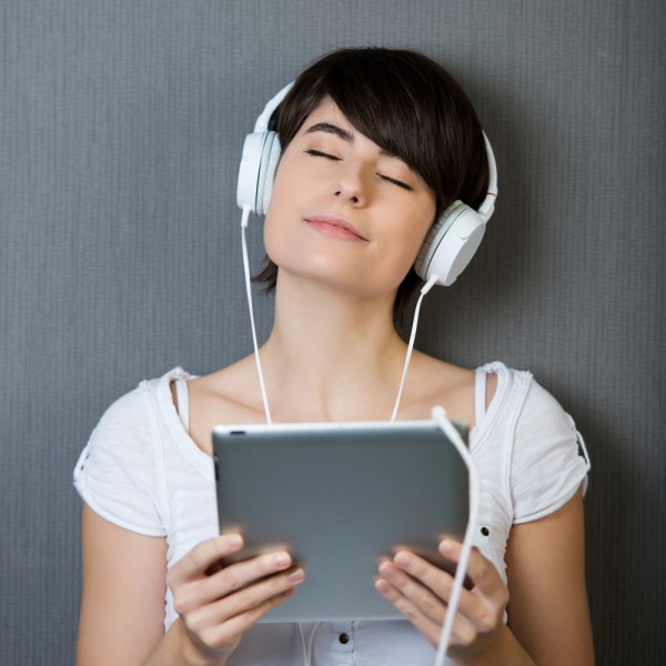 woman-listening-to-music-on-tablet